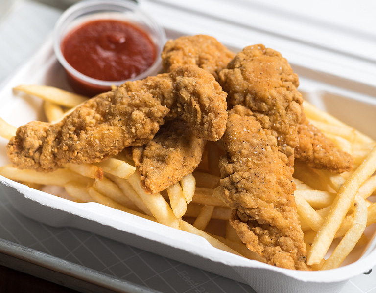 Chicken strips served with French fries and ketchup