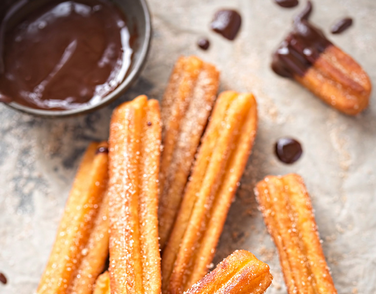 Churros with sugar and chocolate