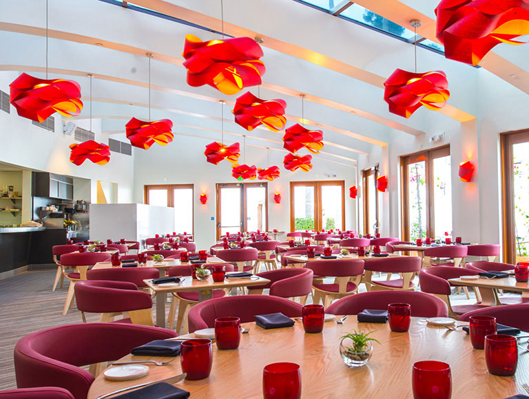 Interior shot of restaurant with red and orange chandeliers.